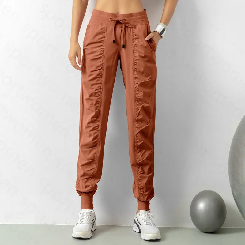 Pantalones de chándal tela shing running sport joggers mujeres fitness de gimnasio atlético seco rápido con dos bolsillos latera