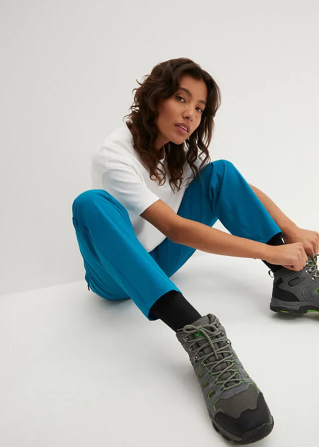 Pantalón elástico en 4 direcciones con material impermeable y bolsillos turquesa profundo